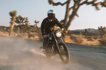 man in black jacket riding motorcycle on road during daytime