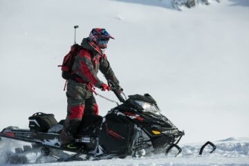 Person Riding on Snowmobile